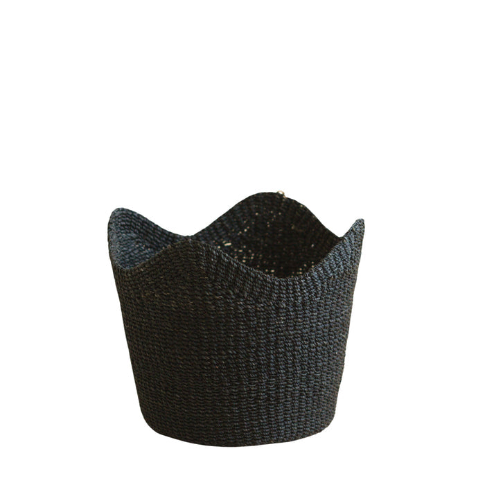 The LIKHA Abaca Scallop Basket, crafted from Manila hemp, features a black woven design with a wavy rim and is displayed elegantly against a white background.
