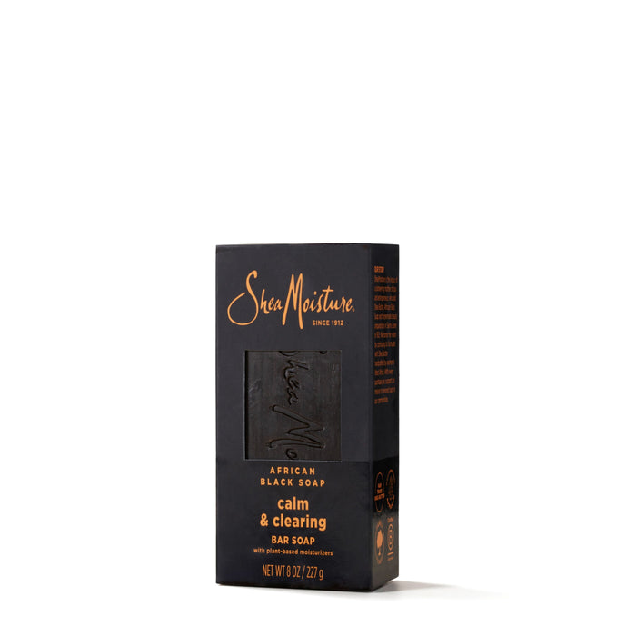 A box of SheaMoisture African Black Soap Bar Soap with Shea Butter, featuring a window that reveals the black soap inside. The natural skin cleanser comes in packaging that is predominantly black with orange and white text.