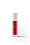 A small cylindrical bottle filled with red liquid and labeled Beetroot Cheek & Lip Tint by Ere Perez features a minimalist design with decorative writing, a white cap, and the natural touch of beetroot extracts against a plain white background.