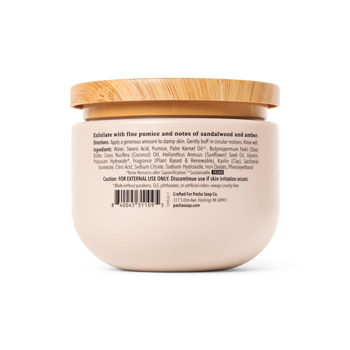 A beige jar of Pacha Soap Co. Body Scrub with a wood-textured lid and a label displaying ingredients, directions, cautions, barcode, brand details, and emphasizing its whipped texture.