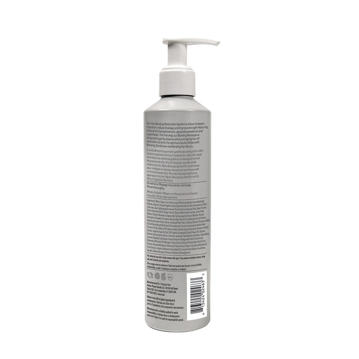 A gray Acure Bonding Shampoo bottle with a white pump and detailed label (including barcode) stands upright against a white background, ideal for hair bonding and hydration.