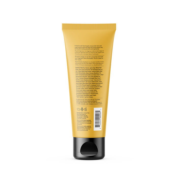 A yellow squeeze tube with a black cap, shown from the back, displays small printed text about Acure Brightening Facial Scrub—including ingredients, a barcode, and recycling symbols—against a plain white background.