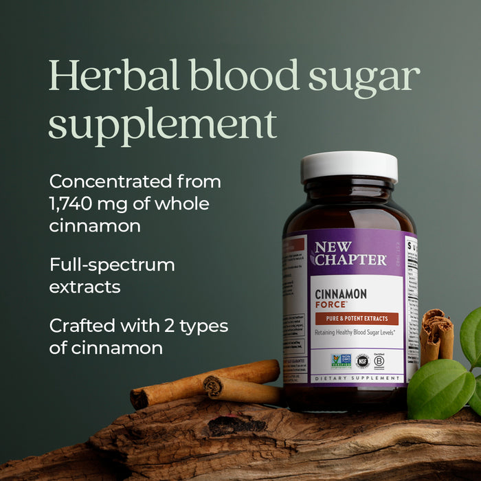 A bottle of New Chapter Cinnamon Force Healthy Blood Sugar Level supplement sits on wood beside cinnamon sticks and powder, with a green backdrop highlighting its vegetarian capsules and Non-GMO benefits.
