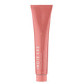 An upright pink tube of Indie Lee Cleansing Balm with white text on a white background—a clean skincare cleanser with vitamin C for radiant skin.