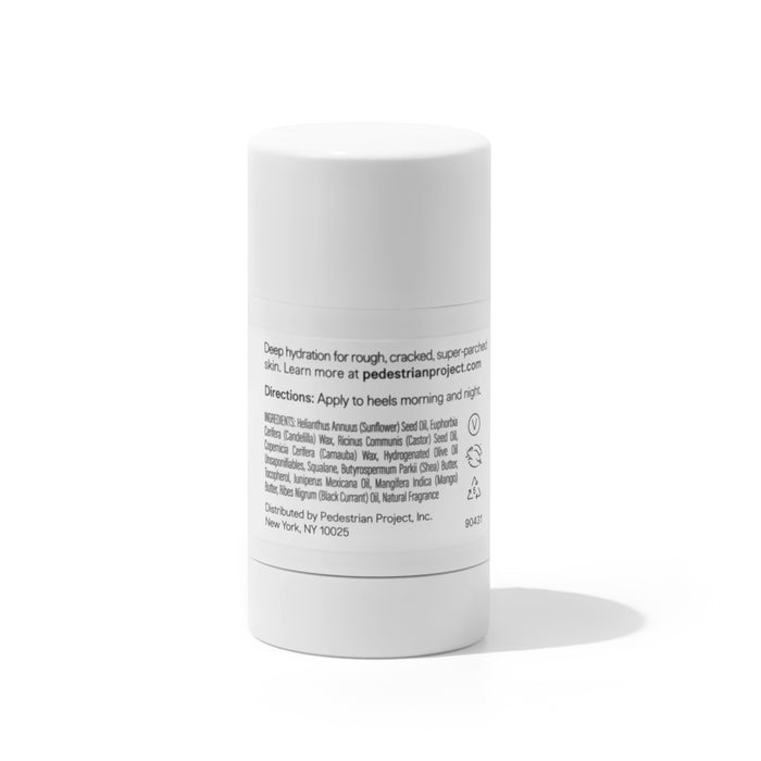 The white cylindrical container of Cracked Heel Repair by Pedestrian Project has a label with usage directions, ingredients, and a New York distribution address. This product is specifically designed to hydrate skin and effectively remedy dry skin issues.