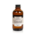 A brown glass bottle of Lovett Sundries Cutting Board Conditioner with a black screw cap stands on a white background. The label highlights Seal & Protect and infused coconut oil for all-natural wood protection.