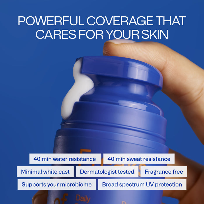 A hand holds a blue Daily Defender SPF30 sunscreen bottle by Freaks of Nature, with white lotion emerging. The text highlights 40 min water and sweat resistance, minimal white cast, dermatologist-tested, fragrance-free, supports microbiome health, vegan spider silk protein for pollution defense, and broad-spectrum protection.