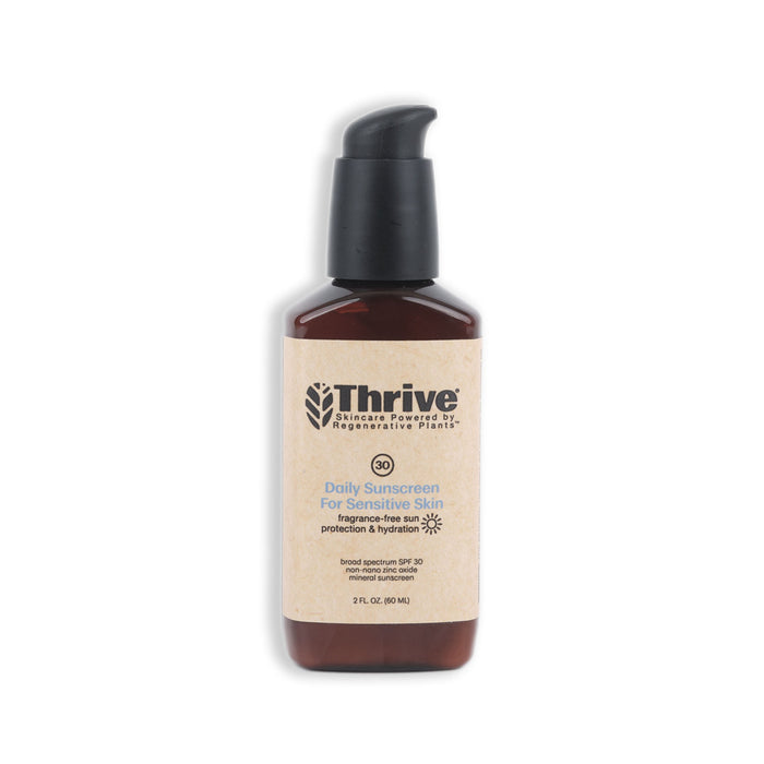 Thrive Natural Cares Daily Sunscreen for Sensitive Skin (SPF 30) comes in a brown bottle with a black pump dispenser and brown label highlighting fragrance-free and broad spectrum UVA/UVB protection. It features non-nano zinc oxide and is set against a plain white background.