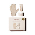 The PAUME Day-to-Night Hand Care Set is displayed with beige gloves, a probiotic hand balm tube, a small jar, and branded packaging all set against a white background.