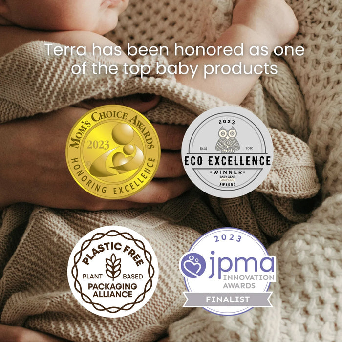 A baby wrapped in a knitted blanket. Overlaid are four awards: Mom's Choice Awards 2023, Eco Excellence Winner 2023, Plastic Free Plant-Based Packaging Alliance, and JPMA Innovation Awards 2023 Finalist. Text reads "Terra has been honored as one of the top baby products.