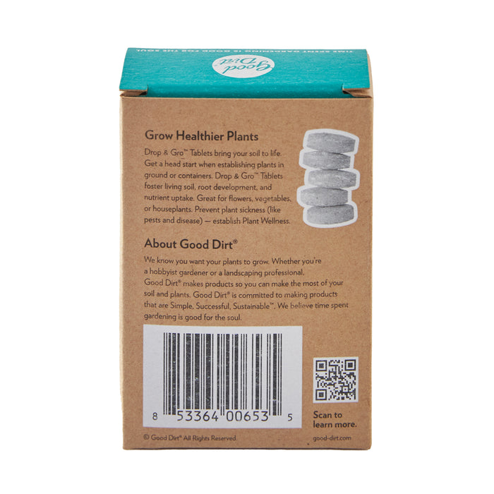 A cardboard box contains Good Dirts Drop & Gro Tablets, showcasing four stacked biostimulant tablets on the front. It highlights benefits for plant growth and soil health, with a barcode, QR code, and company details. The top flap is teal with the Good Dirt logo.
