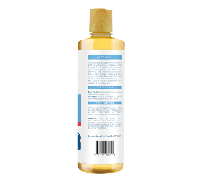 A clear bottle of Dr Jacobs Naturals Eczema Relief Baby Wash has a wooden cap. The label includes directions, ingredients like antioxidant-rich olive and coconut oils, and warnings. The unscented, light yellow liquid stands upright against a white background.