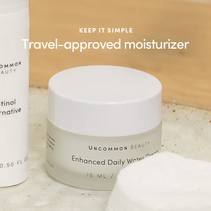A jar of Uncommon Beauty Enhanced Daily Water Cream sits on a beige tray beside skincare products and cotton pads, with the text Keep it simple. Travel-approved lightweight moisturizer above it.