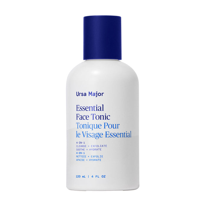 A white bottle with a blue cap labeled Ursa Major Essential Face Tonic in blue and black text, featuring English and French details. This 120 ml (4 fl oz) Ursa Major tonic gently exfoliates skin for a clearer complexion.