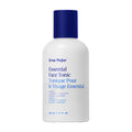 A white bottle with a blue cap labeled Ursa Major Essential Face Tonic in blue and black text, featuring English and French details. This 120 ml (4 fl oz) Ursa Major tonic gently exfoliates skin for a clearer complexion.