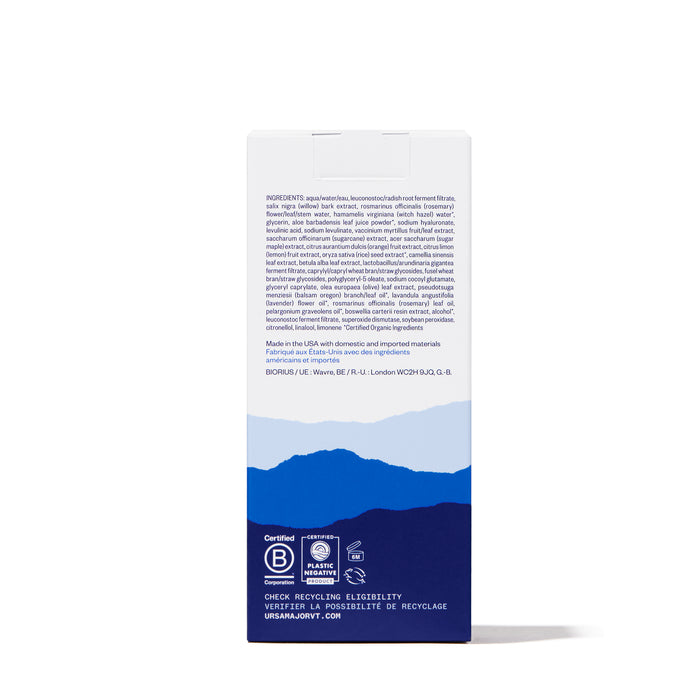A white Ursa Major Essential Face Tonic box featuring blue mountain illustrations, certification logos, recycling info, and product details with ingredients in small blue font on top—this exfoliating tonic promises clearer skin.