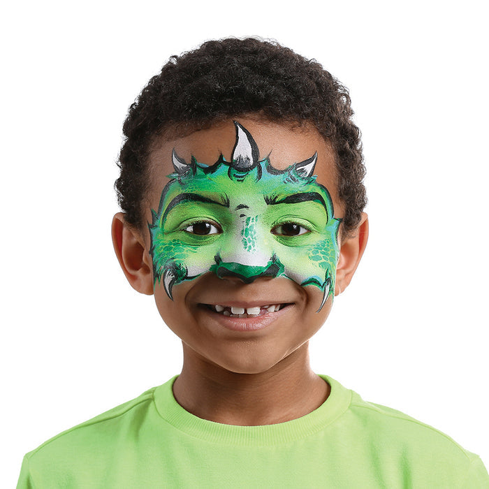 A child beams with delight, their face adorned in vibrant green dragon design using eco-kids Face Paint Set. Detailed black outlines add depth around the eyes and lips. Dressed in a light green shirt against a white background, the sets 10 colors come vividly to life.