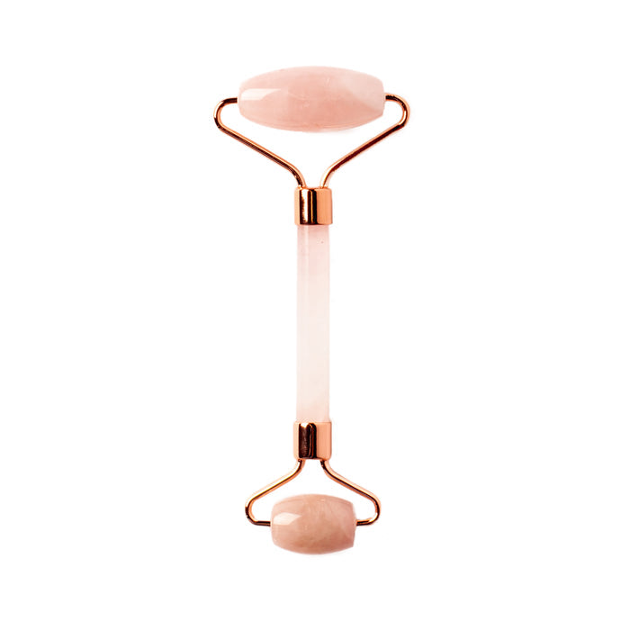 The WTHN Face Roller Kit features two smooth, oval rose quartz stones and rose gold accents, designed to reduce puffiness with a beauty technique inspired by Traditional Chinese Medicine.