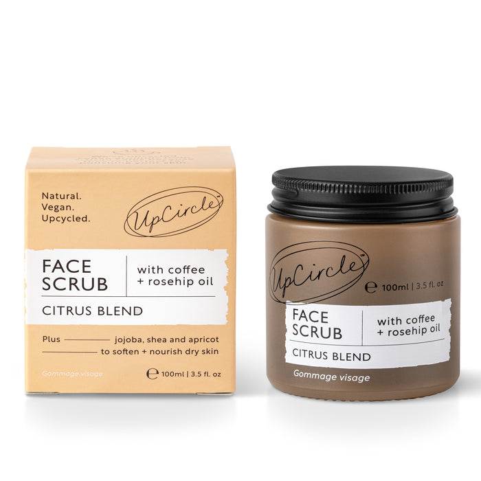 The UpCircle Face Scrub with Coffee + Rosehip Oil - Citrus Blend comes in a jar and box highlighting its vegan nature with earthy packaging. This gentle scrub features rescued coffee grounds, rosehip oil, jojoba, shea, and apricot to exfoliate and nourish dry skin.
