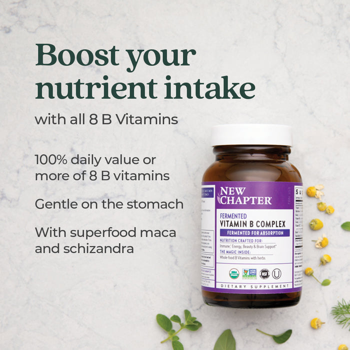 A bottle of New Chapter Fermented Vitamin B Complex sits on a light surface with herbs. Text highlights all 8 B vitamins, 100% daily value, gentle on stomach, plus superfood maca and schizandra for natural energy support.