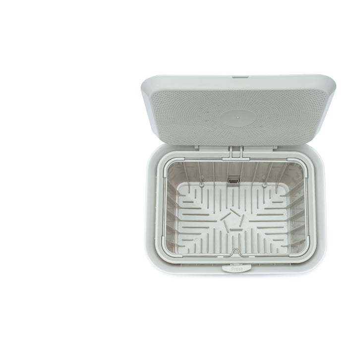 A top view of an empty, open Fresh Air Compost Bin by Full Circle with a hinged lid on a white background. Inside, a removable slotted tray at the bottom helps keep kitchen waste odor-free.