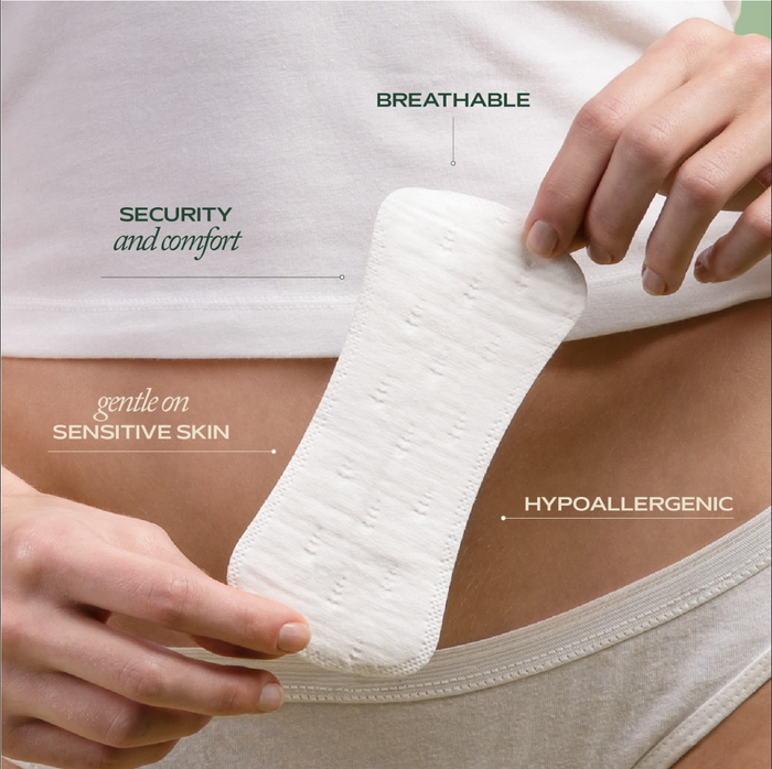 A person in white underwear holds a Hempress Hygienics Hemp Pantyliner by their waist. Text highlights features: secure & comfortable, breathable, gentle on sensitive skin, hypoallergenic, and made with organic hemp.