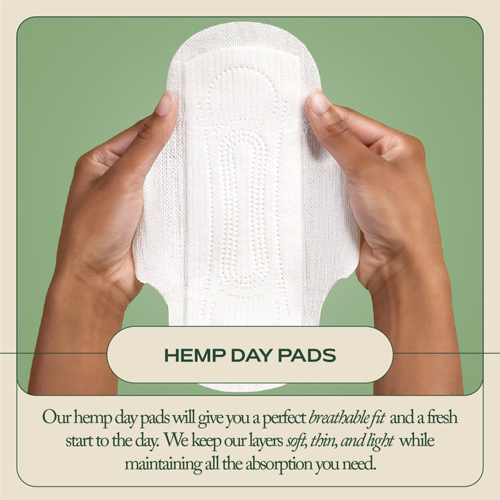 Two hands hold a Hemp Regular Pad by Hempress Hygienics, crafted from pesticide-free hemp and organic cotton. Against a green backdrop, text highlights its breathable, soft, thin design with strong absorption—ideal daily comfort for menstrual health champions.