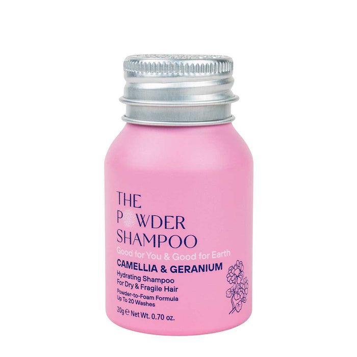 A pink bottle of The Powder Shampoos Hydrating & Replenishing Powder Shampoo features a silver cap. The formula, infused with camellia and geranium, is perfect for dry or processed hair, offering 10-20 washes in just 20g (0.70 oz) with its unique powder-to-foam innovation.