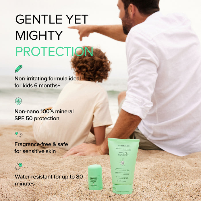 A man and young child sit on a sandy beach, with the man pointing toward the water. In the foreground are two MDSolarSciences KidCreme SPF 50 mineral sunscreens, offering gentle yet strong protection for kids six months and older.