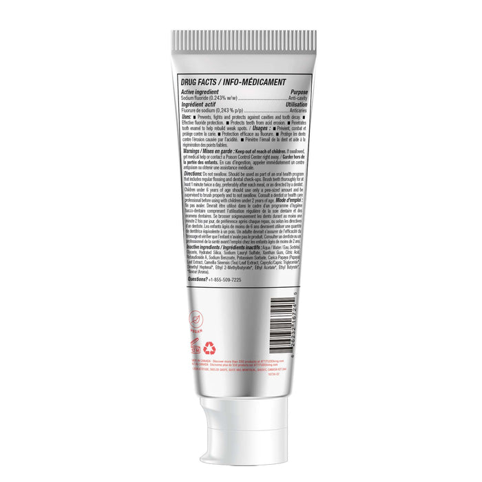 A silver and white tube of ATTITUDE little leaves Toothpaste with Fluoride, featuring a white cap and back label displaying drug facts, ingredients, fluoride content, warnings, usage instructions in black text, plus recycling symbol and contact info at the bottom.