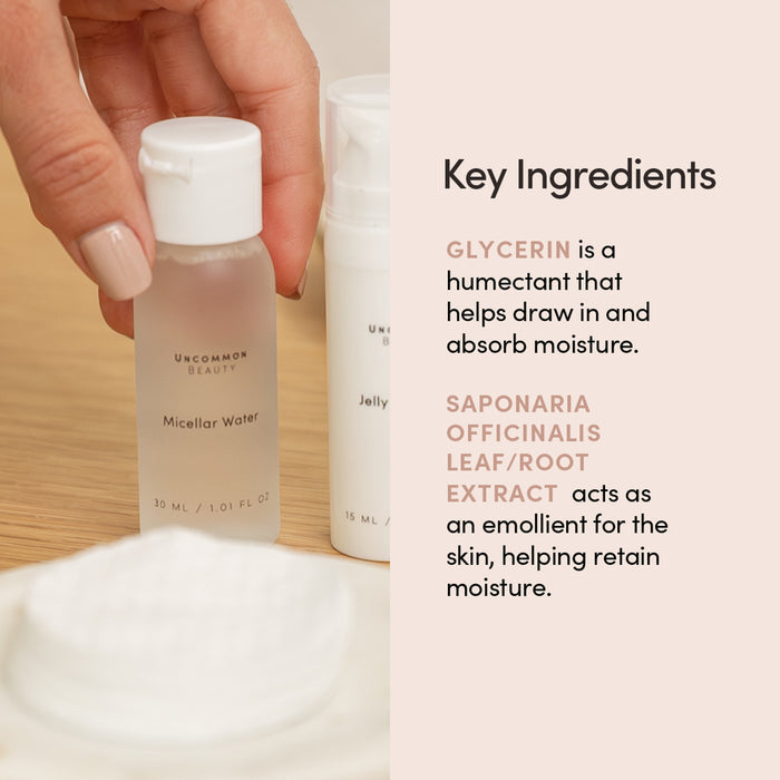 A hand holds a Uncommon Beauty Mini Micellar Water bottle, a gentle cleanser and makeup remover, beside another skincare item. Text highlights key ingredients: glycerin for moisture and saponaria officinalis leaf/root extract to retain it.
