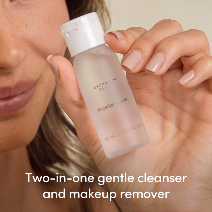 A person holds a Mini Micellar Water bottle from Uncommon Beauty; text overlay: Gentle two-in-one cleanser and makeup remover for all skin types.
