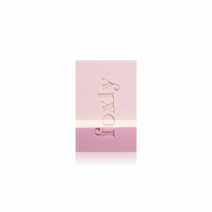 The Foxly Moisturizing Bar Soap is a rectangular, two-toned pink handcrafted soap with "lovly" engraved vertically on the front, made with nourishing oils and shown on a white background.