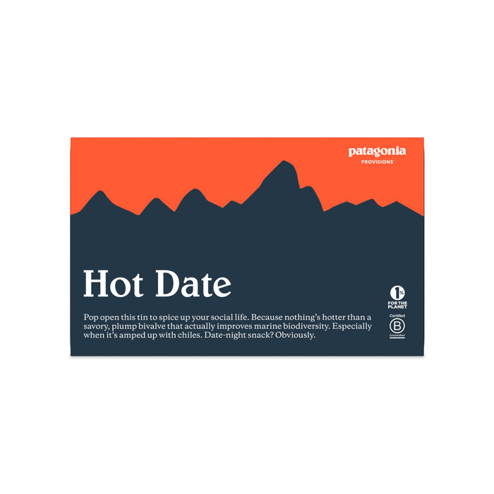 A rectangular tin features a dark blue mountain silhouette on an orange sky. The label reads “Mussels Spicy” by Patagonia Provisions, describing responsibly sourced spicy mussels in extra virgin olive oil.