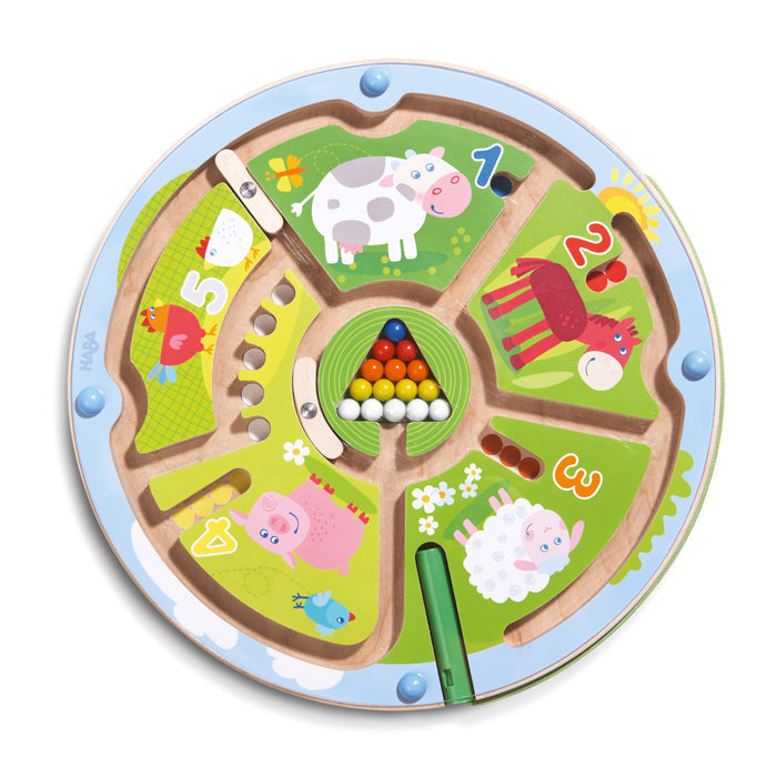 The HABA Number Maze Magnetic Game for ages 2+ is a round wooden board with farm animal illustrations, numbered sections 1-5, and colorful balls to move using a magnetic stylus. Includes cow, horse, sheep, pig, and chickens.