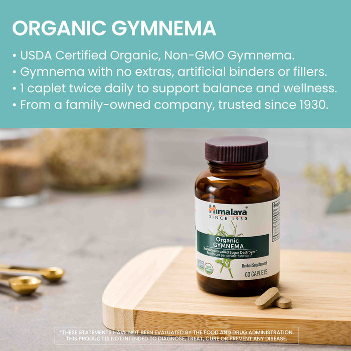 Image of a bottle of Himalaya Organic Gymnema supplements on a wooden cutting board. The green and white product label is visible, with several caplets scattered nearby. Text on the image highlights the organic certification, absence of extras, and intake recommendation.