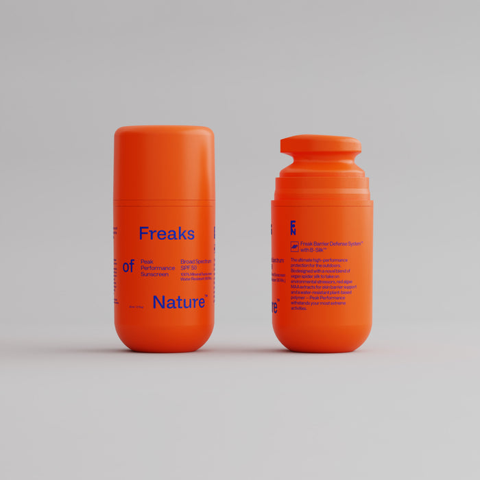 Two orange cylindrical bottles of Peak Performance SPF50 Sunscreen by Freaks of Nature are shown on a plain background. One bottle is upright with visible text; the other, a side view with a flip-top cap, highlights its non-nano zinc formula.