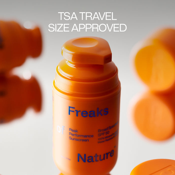 The Freaks of Nature Peak Performance SPF50 Sunscreen shows off its orange bottle with non-nano zinc, TSA travel-approved size. Blurred duplicates highlight its compact design, while being gentle on your microbiome.