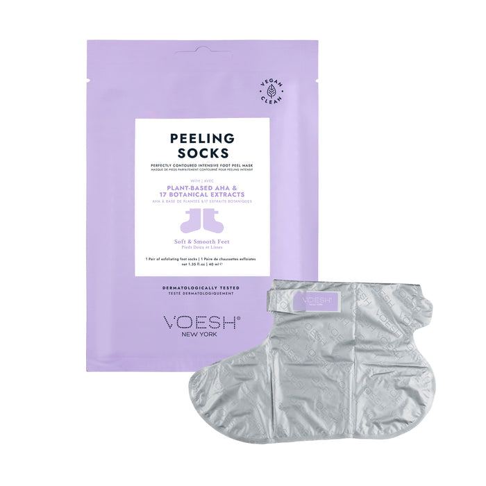 Image of VOESH New Yorks Peeling Socks Duo in lavender packaging with a silver sock. The package showcases vegan ingredients, including plant-based AHA and 17 botanical extracts, emphasizing its cruelty-free promise. The transparent exfoliating sock has a textured design.