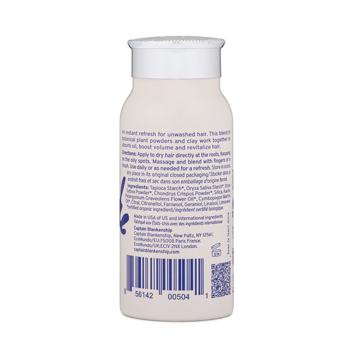The beige cylindrical bottle of Refresh Dry Shampoo by Captain Blankenship features a label with text and a barcode, detailing product usage and ingredients infused with essential oils, topped with a white cap.