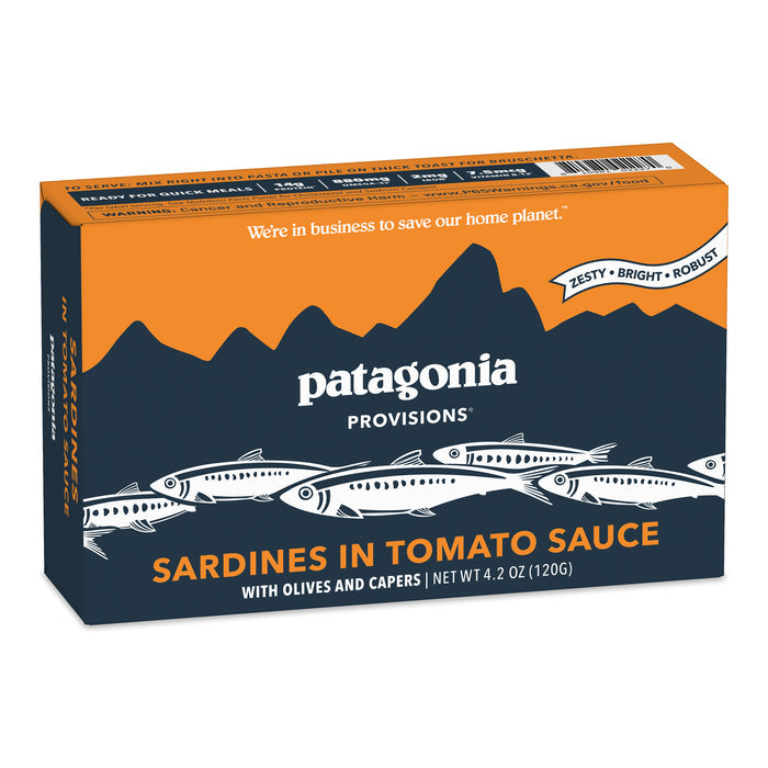 Patagonia Provisions Sardines Tomato Sauce come in a 4.2 oz (120g) rectangular box with orange and dark blue packaging, featuring sardine and mountain illustrations. Responsibly sourced, these tinned sardines have notes of olives and capers.