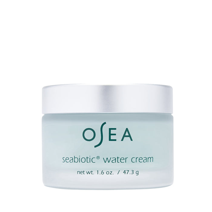 The Seabiotic® Water Cream by OSEA, dermatologist-approved for enhanced skin radiance, features a light blue label and white lid. The jar displays a net weight of 1.6 oz. (47.3 g) against a plain white background.