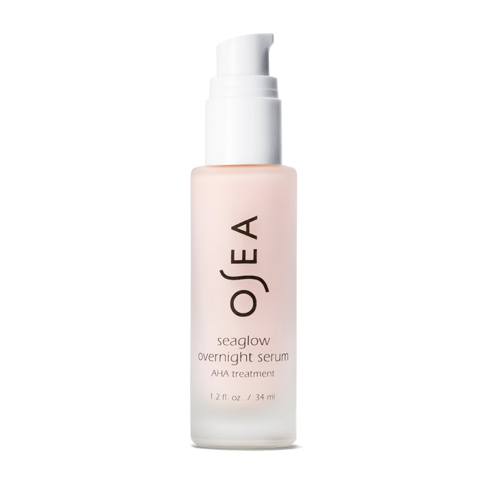 A frosted 1.2 fl. oz/34 ml glass bottle of OSEAs Seaglow Overnight Serum, featuring a white pump cap and sleek black text, is ready for your skincare routine. The label promises an AHA treatment for a smoother complexion.