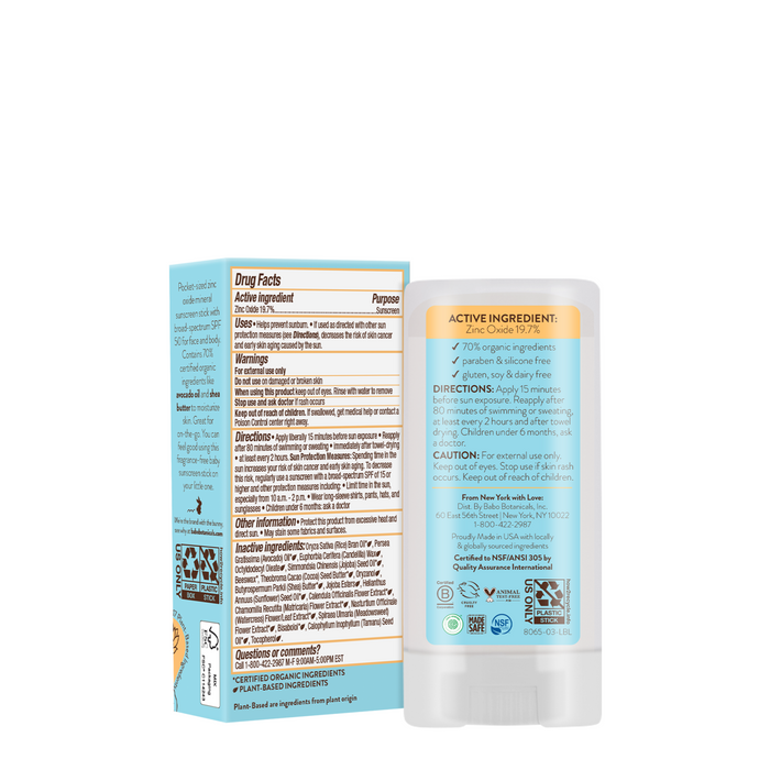 A Babo Botanicals Sensitive Baby Mineral Sunscreen Stick SPF50 is shown with its box, featuring white packaging with blue and orange accents, and highlighting SPF50 protection, mineral ingredients, directions, cautions, and drug facts on the back labels.