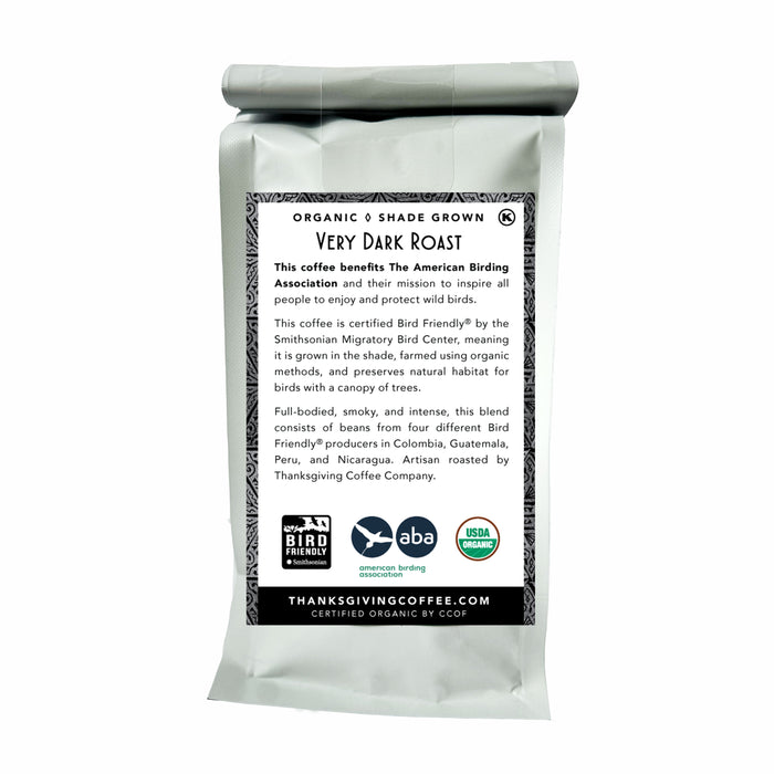 The Songbird French Very Dark by Thanksgiving Coffee comes in a silver bag, featuring Bird Friendly, ABA, and USDA Organic labels. This sustainable coffee is organic and shade-grown, benefiting the American Birding Association, and is sourced from Colombia, Guatemala, Peru, and Nicaragua.