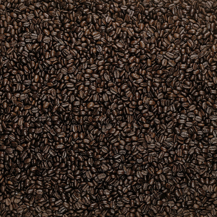 A close-up view of numerous Songbird French Very Dark beans from Thanksgiving Coffee, spread uniformly across the image to create a rich brown textured background. The shiny surface suggests they are freshly roasted.