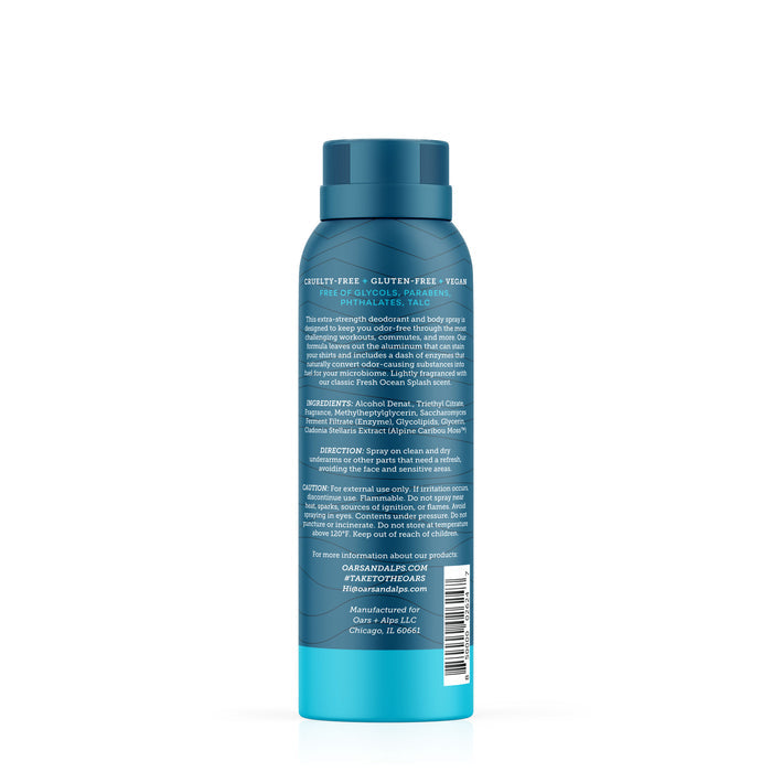A blue Oars + Alps Spray Deodorant bottle is shown from the back, featuring product info, ingredients, and directions in white text. The California Coast scent and brand contact details appear at the bottom.