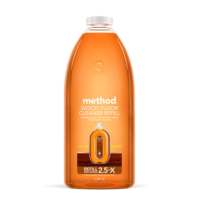 Displayed is a Method Squirt Mop Wood Floor Cleaner Refill in recycled plastic. The almond-scented cleaners orange label with white text indicates it contains 2.5 times more than the standard size, ideal for your cleaning needs.