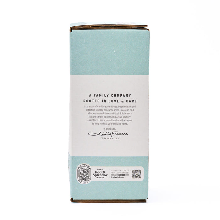 A light blue and white box for Root and Splendor’s Stain Remover Refill shares a family company message, displays the founder’s signature, brand logo, and features a QR code at the bottom.