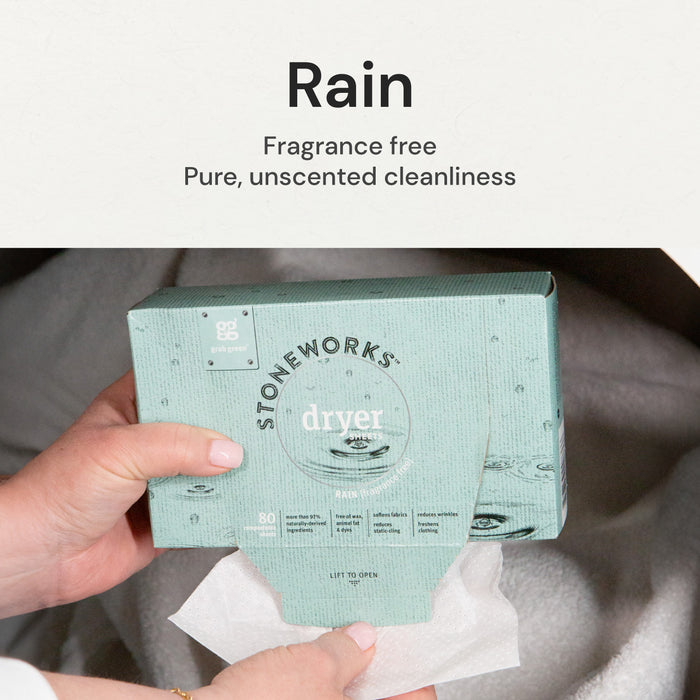 A person holds a box of grab greens Stoneworks Dryer Sheets - Rain - NEW, crafted with natural ingredients and fragrance-free. The recycled paper packaging promises pure cleanliness and effectively reduces static cling.